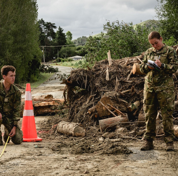 Private Tyack (Tong) takes measurements and Private Williams details the information to supply to army engineers. 