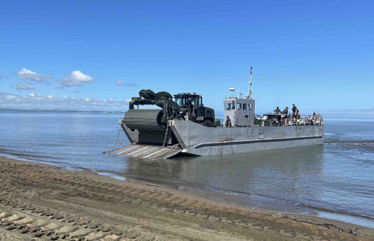 The CAT938K (with Faun Trackway on the front) drives off a landing craft on to Lomolomo Beach during Operation Mahi Tahi