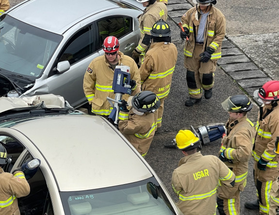 Firefighters use the jaws of life on a mock car wreck scenario.