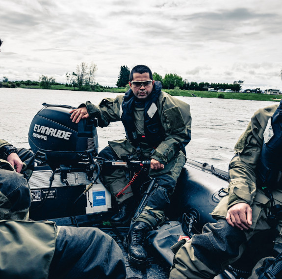 Sapper Mistry and three other Reserve Force personnel in a small inflatable boat. 