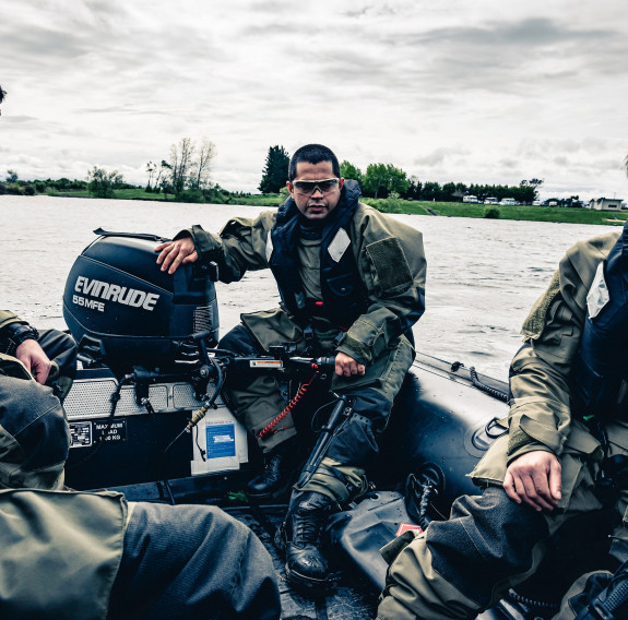 Sapper Mistry and three other Reserve Force personnel in a small inflatable boat.