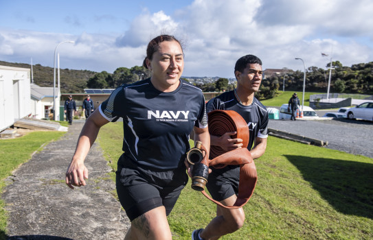 Sub Lieutenant Tyler Simeon, alongside Midshipman Tevita Tu’uta, conducts a fire exercise at the Navy’s Tamaki Leadership Centre, Whangaparaōa Peninsula.