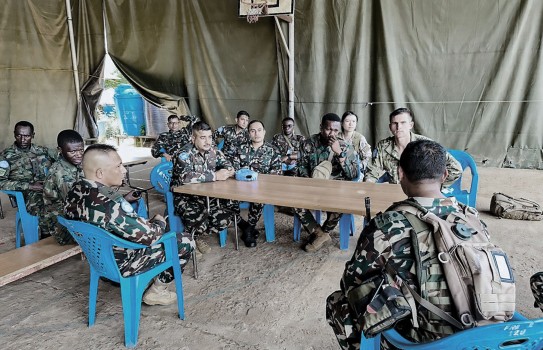 Peacekeepers talking around table in tent