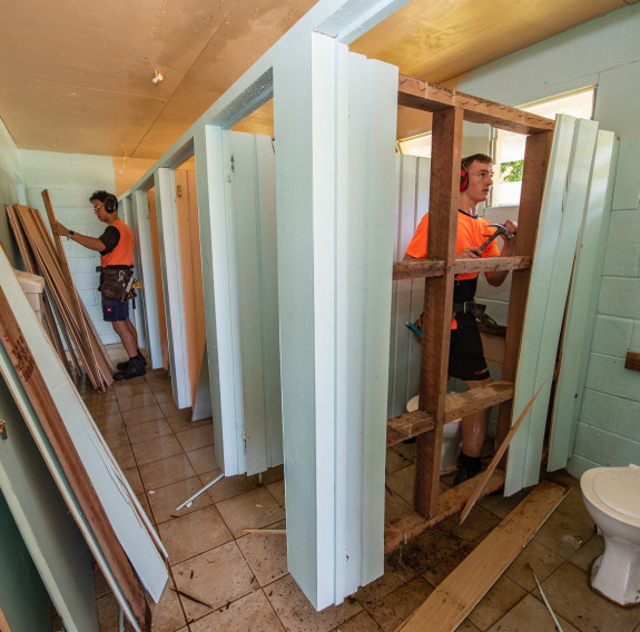 NZDF personnel demolishing the ablution facilities at Niue High School as part of Operation Tropic Twilight