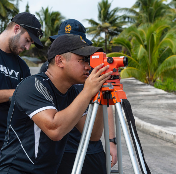 Able Hydrographic Survey Officer Nicoli Demafilez (on the theodolite) and AHSO Innes Bingham carry out survey work