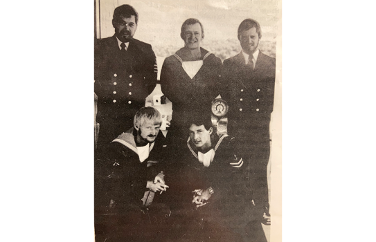 Sepia tone photograph of the five Stokes brothers while in service, wearing their Navy uniforms.