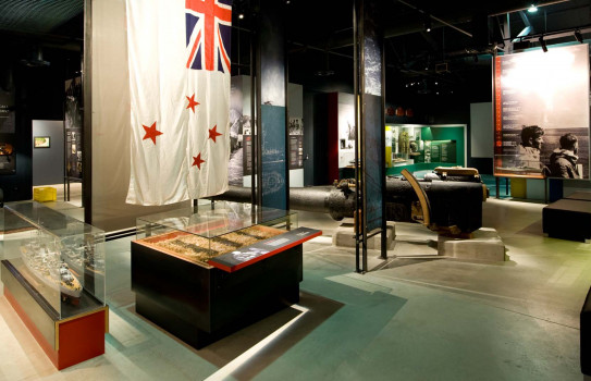 Inside the Torpedo Bay Navy Museum with the White Ensign showcased