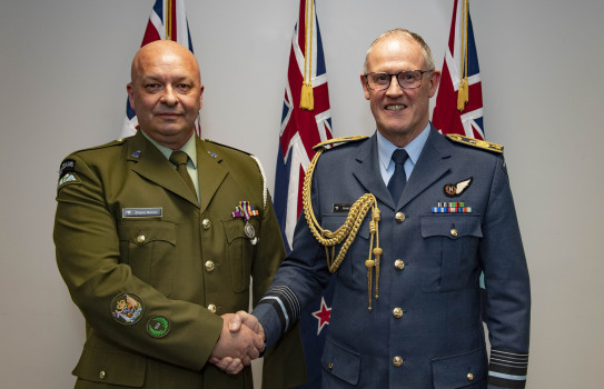 Chief of Defence Force, Air Marshal Kevin Short, presents a Defence Meritorious Service Medal to Warrant Officers Class One Shane Maslin