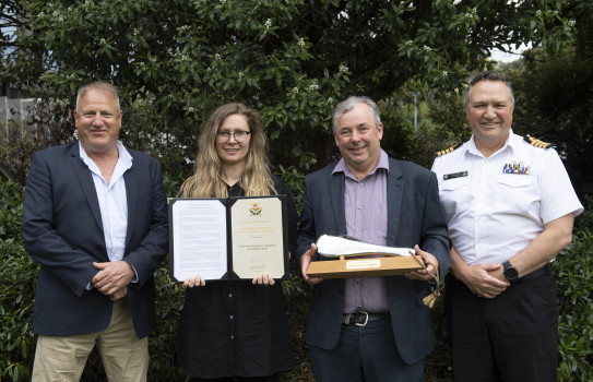 Innovation of the Year 2021 award winners hold award and certificate, with smiling faces.