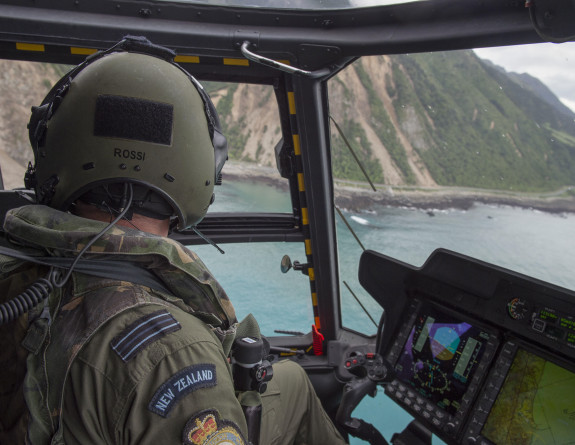 A pilot surveys damage to Kaikōura's coastal road after the 2016 Kaikōura earthquake from the cockpit of an NH90 helicopter.